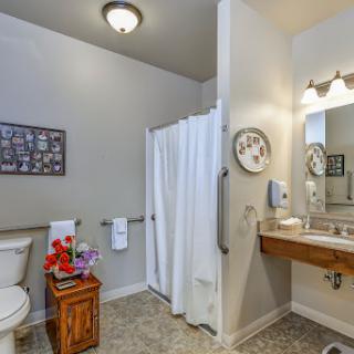 A well-lit bathroom featuring modern amenities and a clean, organized layout.