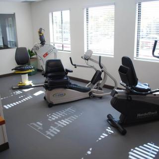 A small gym room with exercise bikes and fitness equipment.