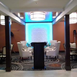 A well-decorated dining room with modern lighting and elegant seating.