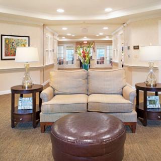 A cozy living room with a comfortable sofa, stylish lamps, and elegant decor.