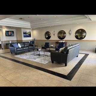 A modern lobby with comfortable seating arrangements and decorative mirrors.
