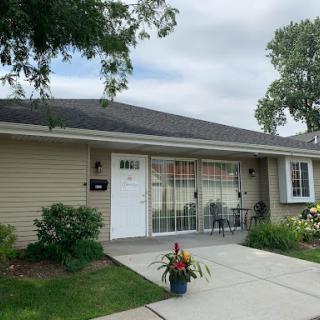 A charming residential house with a well-maintained front yard and colorful flowers.