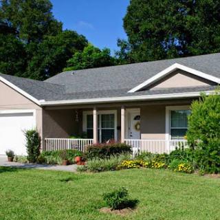 A charming single-story house with a well-maintained front yard and welcoming porch.