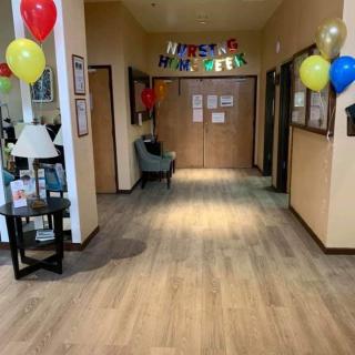A decorated hallway with colorful balloons and a welcome banner.