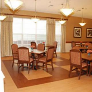 A cozy dining area with tables and chairs in a well-lit room.