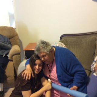A warm embrace between two people in a cozy living room setting.