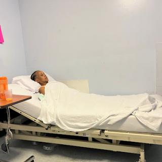 A patient resting in a hospital bed.