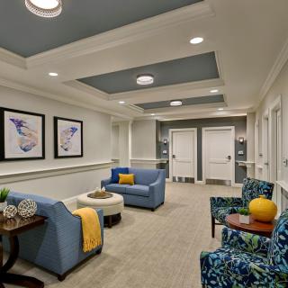 A modern waiting room with comfortable seating and elegant decor.