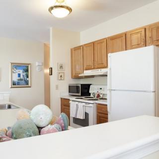 A cozy kitchen with wooden cabinets and modern appliances.