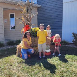 A joyful family gathering amidst fall decorations, celebrating the season.