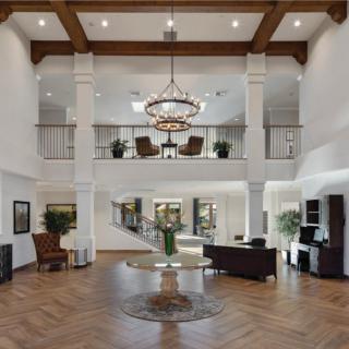 A spacious and elegantly designed lobby with modern furnishings and a grand chandelier.