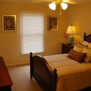 A cozy bedroom with warm lighting and elegant furniture.