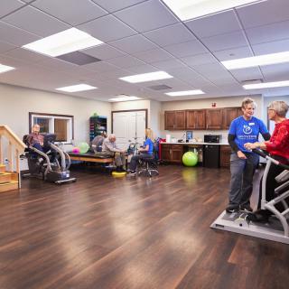 A group of individuals engaged in physical therapy exercises in a healthcare facility.