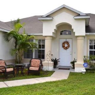 A cozy suburban home with a welcoming front porch and garden.