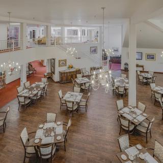 An elegant restaurant dining area with arranged tables and chandeliers.