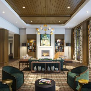 A modern and elegant hotel lobby featuring a cozy seating area with a fireplace and artwork.