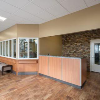 A modern reception area featuring wooden flooring and contemporary decor.