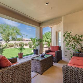 A cozy outdoor patio with comfortable seating, perfect for relaxation and enjoying the view of the garden.