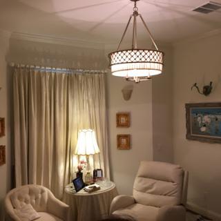 A cozy living room featuring soft lighting, comfortable seating, and elegant decor.