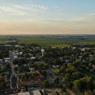 A serene aerial view of a small town nestled in the countryside during sunset.