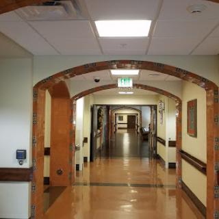 A well-lit hallway inside a hospital, showcasing the architectural design.