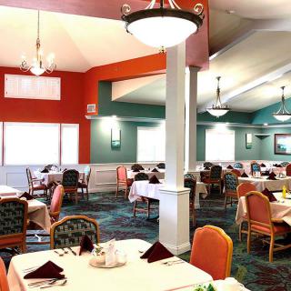 A well-lit restaurant interior with neatly arranged dining tables and colorful decor.