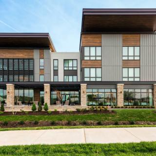 A modern building with a sleek architectural design and landscaped surroundings.