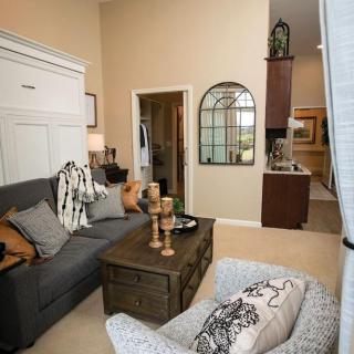 A cozy, modern living room with a comfortable sofa, decorative pillows, and a stylish coffee table.