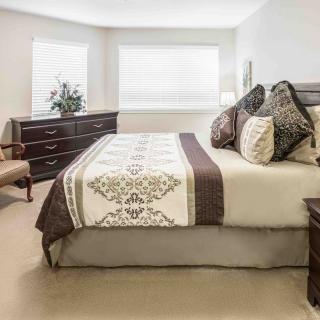 A well-decorated bedroom with a comfortable bed and elegant furnishings.