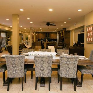Modern dining room with an elegant table and chairs in an open-concept space.