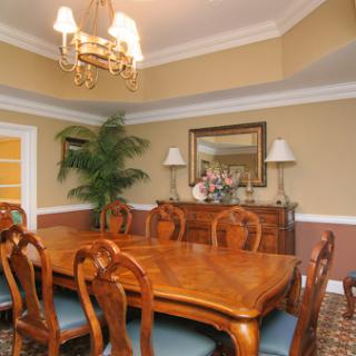 A beautifully arranged dining room featuring elegant wooden furniture and an inviting atmosphere.