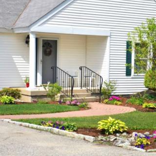 A well-maintained front yard with a walkway and landscaped garden.
