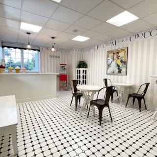 A modern dining area featuring a minimalist design with black and white tiled flooring.