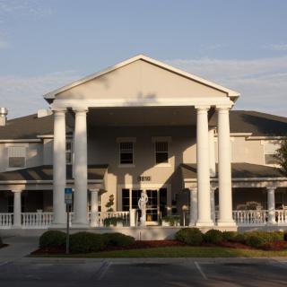 A large residential building with prominent columns at the entrance.