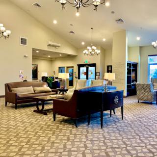 A spacious and inviting lobby area featuring modern furniture and elegant lighting.