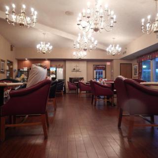 An elegant dining room with chandeliers and comfortable seating.