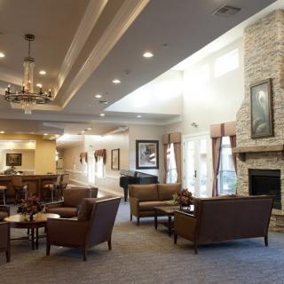 A spacious lobby with comfortable seating and a cozy fireplace.