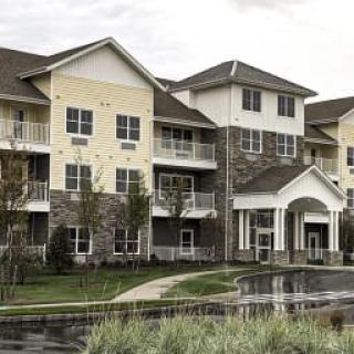 A modern apartment complex with multiple stories and balconies.