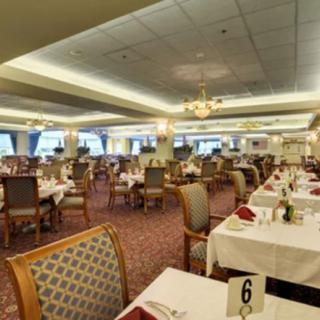 An elegant dining room with neatly arranged tables and chairs, ready for guests.