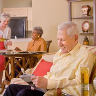 A group of elderly individuals enjoying a relaxed moment in a cozy living room.
