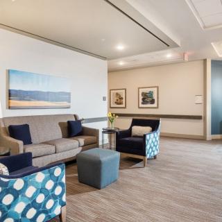 A modern waiting room with comfortable seating and artistic decor.