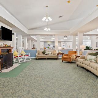 A spacious living room with comfortable seating and a fireplace.