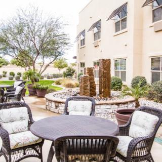 An inviting outdoor patio area with comfortable seating and landscaped garden features.