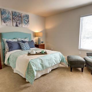 A cozy and modern bedroom with a neatly made bed, soft lighting, and stylish decor.