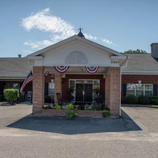 The main entrance of a building decorated with patriotic flags.