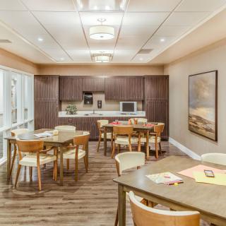 A modern kitchen and dining area with wooden furnishings and ample seating.
