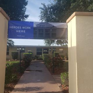 Entrance to a residential or community area featuring a banner.