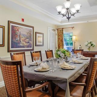 A beautifully set dining room with elegant decor and lighting.