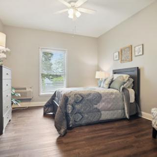A cozy and modern bedroom featuring a comfortable bed, stylish decor, and plenty of natural light.