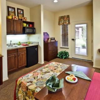 A cozy kitchen and dining area with a table, chairs, and modern appliances.